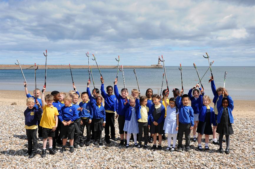 Pupils from Dame Dorothy Primary School taking part in a pre triathlon beach clean up