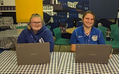 two women with laptops