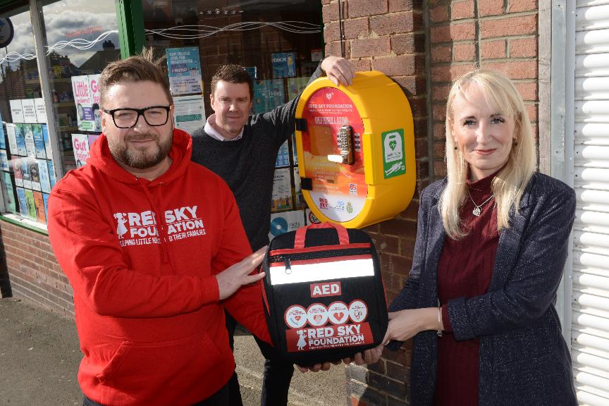 Sergio Petrucci of Red Sky Foundation, Cllr Kelly Chequer, Chair of Sunderland Health and Wellbeing Board and Copt Hill councillor Cllr Kevin Johnston at the new defibrillator in Houghton